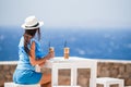 Young woman drinking cold coffee enjoying sea view. Royalty Free Stock Photo