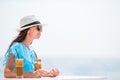 Young woman drinking cold coffee enjoying sea view. Royalty Free Stock Photo