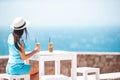 Young woman drinking cold coffee enjoying sea view Royalty Free Stock Photo