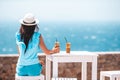 Young woman drinking cold coffee enjoying sea view Royalty Free Stock Photo