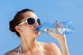 Young woman is drinking cold water from the bottle Royalty Free Stock Photo