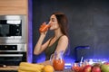 Young woman drinking fresh juice in the domestic kitchen Royalty Free Stock Photo