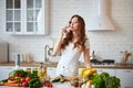 Young woman drinking fresh water from glass in the kitchen. Healthy Lifestyle and Eating. Health, Beauty, Diet Concept Royalty Free Stock Photo