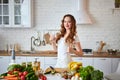 Young woman drinking fresh water from glass in the kitchen. Healthy Lifestyle and Eating. Health, Beauty, Diet Concept Royalty Free Stock Photo