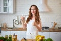 Young woman drinking fresh water from glass in the kitchen. Healthy Lifestyle and Eating. Health, Beauty, Diet Concept Royalty Free Stock Photo