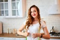 Young woman drinking fresh water from glass and showing thumbs up in the kitchen. Healthy Lifestyle and Eating. Health, Beauty, Royalty Free Stock Photo