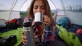 Woman drinking hot tea from mug. Hiker enjoying coffee during hike in mountains Royalty Free Stock Photo