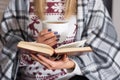 Cozy Winter Night: Woman Enjoying Tea and Reading Royalty Free Stock Photo