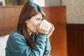 young woman drinking hot tea in winter, asian female enjoying a cup of coffee at home in the morning Royalty Free Stock Photo