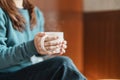 young woman drinking hot tea in winter, female hand holding and enjoying a cup of coffee at home in the morning Royalty Free Stock Photo