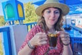 Young woman drinking jasmine tea with almonds in an arabic cafe. Blue and white interior in Sidi Bou Said, Tunisia