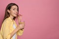 Young woman drinking lemon water on background. Space for text Royalty Free Stock Photo