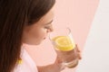 Young woman drinking lemon water