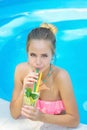 Young woman drinking lemonade in the pool Royalty Free Stock Photo