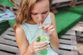 Young woman drinking with lime and mint cocktail with drinking straw in glass Royalty Free Stock Photo