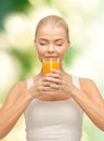 Young woman drinking orange juice Royalty Free Stock Photo