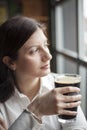 Young Woman Drinking a Pint of Stout Royalty Free Stock Photo