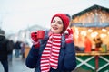 Young woman drinking punch on christmas market Royalty Free Stock Photo