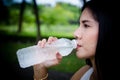 Young woman drinking pure water from plastic bottle. Royalty Free Stock Photo