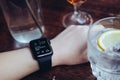Young woman drinking with smart watch at bar Royalty Free Stock Photo