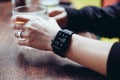 Young woman drinking with smart watch at bar Royalty Free Stock Photo