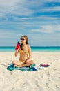 Young woman drinking sparkling water from transparent bottle on the beach, cancun Royalty Free Stock Photo