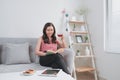Young woman drinking tea while reading a book on the couch Royalty Free Stock Photo