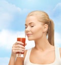 Young woman drinking tomato juice Royalty Free Stock Photo