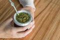 Young woman drinking traditional Argentinian yerba mate tea.