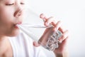 Young woman drinking water. Female model holding glass in her ha