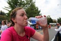 Young woman drinking water at finish line of half marathon,Saratoga Springs,New York,September 15th,2013