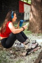 Young woman drinking water after rollerblading exercise