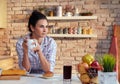 Young woman drinks breakfast coffee in pyjama