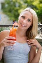 Young woman drinks cocktail outdoor on a hot summer afternoon in Royalty Free Stock Photo