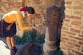 Young woman drinks from a drinking fountain Royalty Free Stock Photo