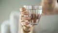 Young woman drinks a glass of water