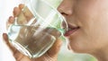 Young woman drinks a glass of water