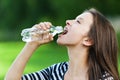 Young woman drinks water bottle Royalty Free Stock Photo