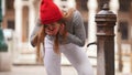 A young woman drinks water from a street fountain Royalty Free Stock Photo