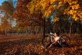 Young woman drinks water after workout on bike. Healthy lifestyle. Riding bicycle in autumn forest Royalty Free Stock Photo