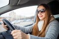 Young woman drive a car in winter