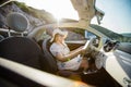 Young woman drive and having fun in cabrio against mountains - travel and summer voyage nature concept