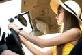 Young woman driver behind a steering wheel driving a car Royalty Free Stock Photo