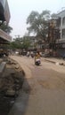 A young woman drives scooter on turning road of India, Maharashtra