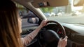 Young woman driving automobile with extended sun visor, safe transportation Royalty Free Stock Photo