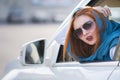 Young woman driving a car backwards. Girl with funny expression on her face while she made a fender bender damage to a rear Royalty Free Stock Photo