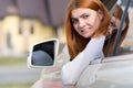 Young woman driving a car backwards. Girl with funny expression on her face while she made a fender bender damage to a rear Royalty Free Stock Photo