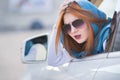 Young woman driving a car backwards. Girl with funny expression on her face while she made a fender bender damage to a rear Royalty Free Stock Photo