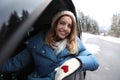 Young woman driving car and looking out of window. Winter vacation Royalty Free Stock Photo