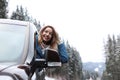 Young woman driving car and looking out of window on road Royalty Free Stock Photo